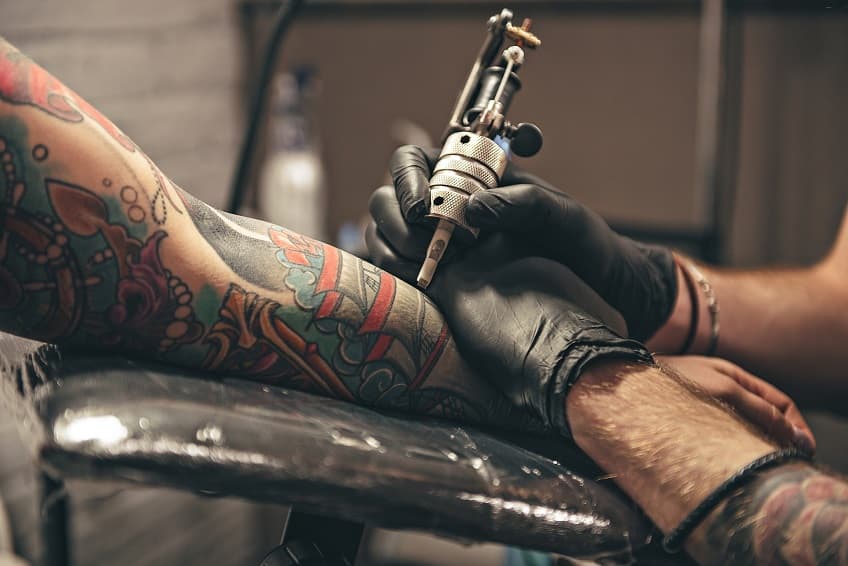 Tattoo artist working